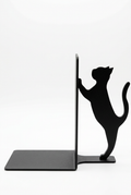 Black cat-shaped book stand on a white background