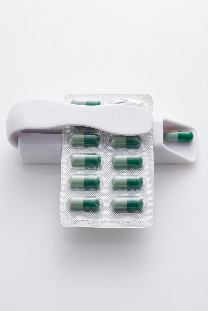 Pill remover demonstration on white background
