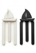 White and black sailboat-shaped bookmarks on a white background