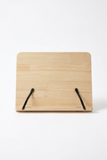 Natural wooden book reading stand with two black page-holding arms on a white background