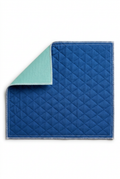 Blue quilted reusable chair pad with folded corner showing mint-green backing on a white background