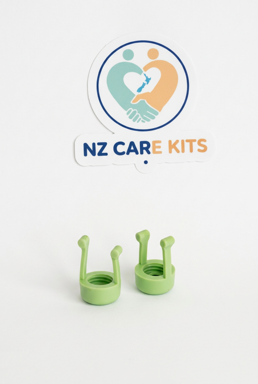Two green eye drop dispenser aids with open circular bases on a white background