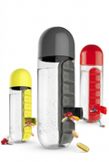 Yellow, grey and red water bottles with attached pill cases on a white background